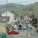 What is the geographic and economic significance of caravan parks in Towyn Wales